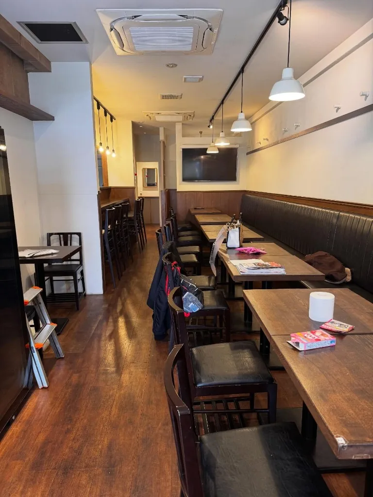 Interior dining area of Akariya izakaya with booth seating and warm lighting